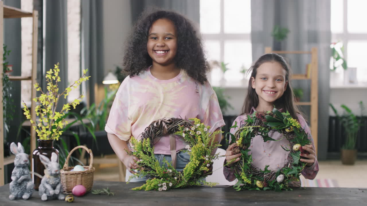 Portrait of Happy Girls with Easter Flower Wreaths