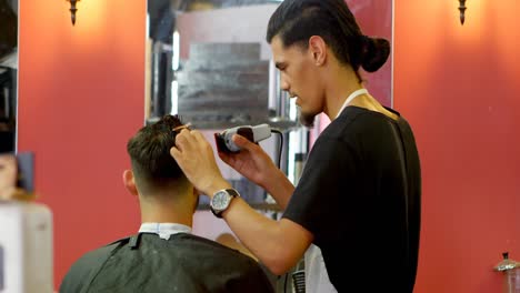 Man-getting-his-hair-trimmed-with-trimmer-4k