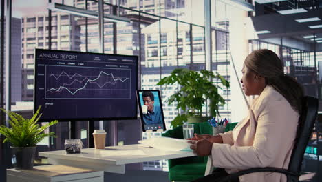 businesswoman in video conference reviewing annual report