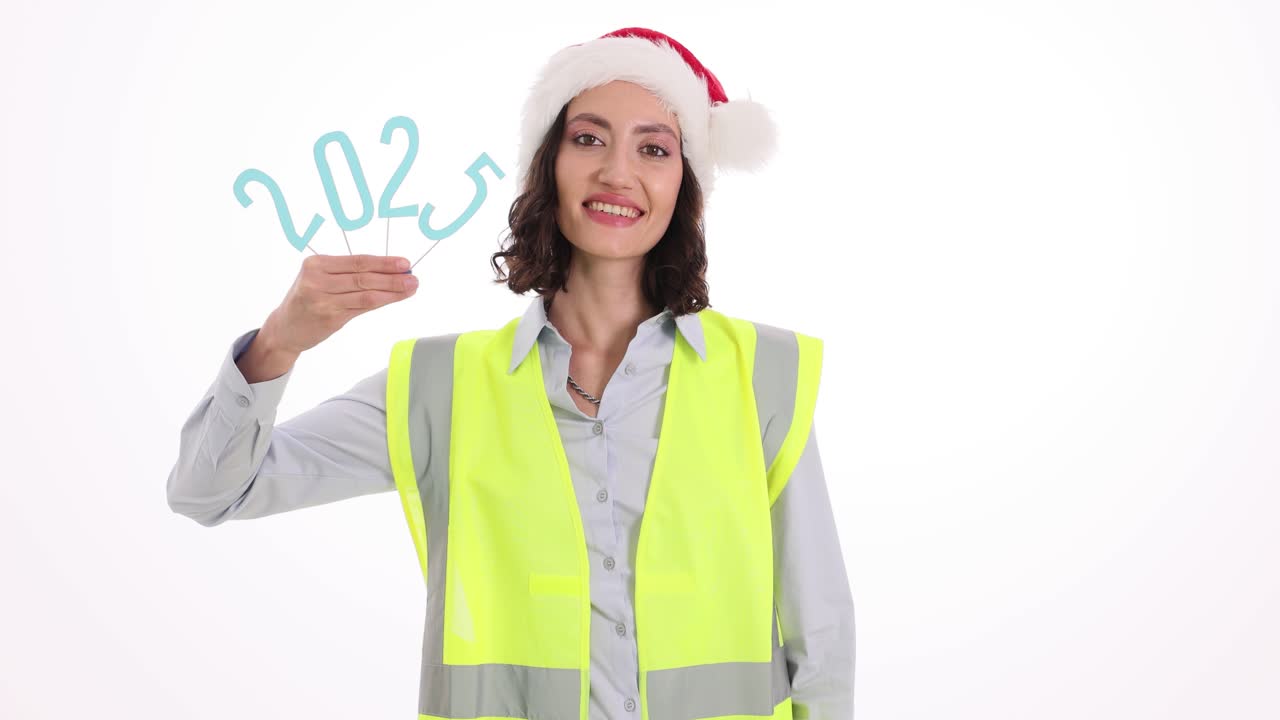 Woman in Santa Hat and Safety Vest Holding 2023 New Year Numbers