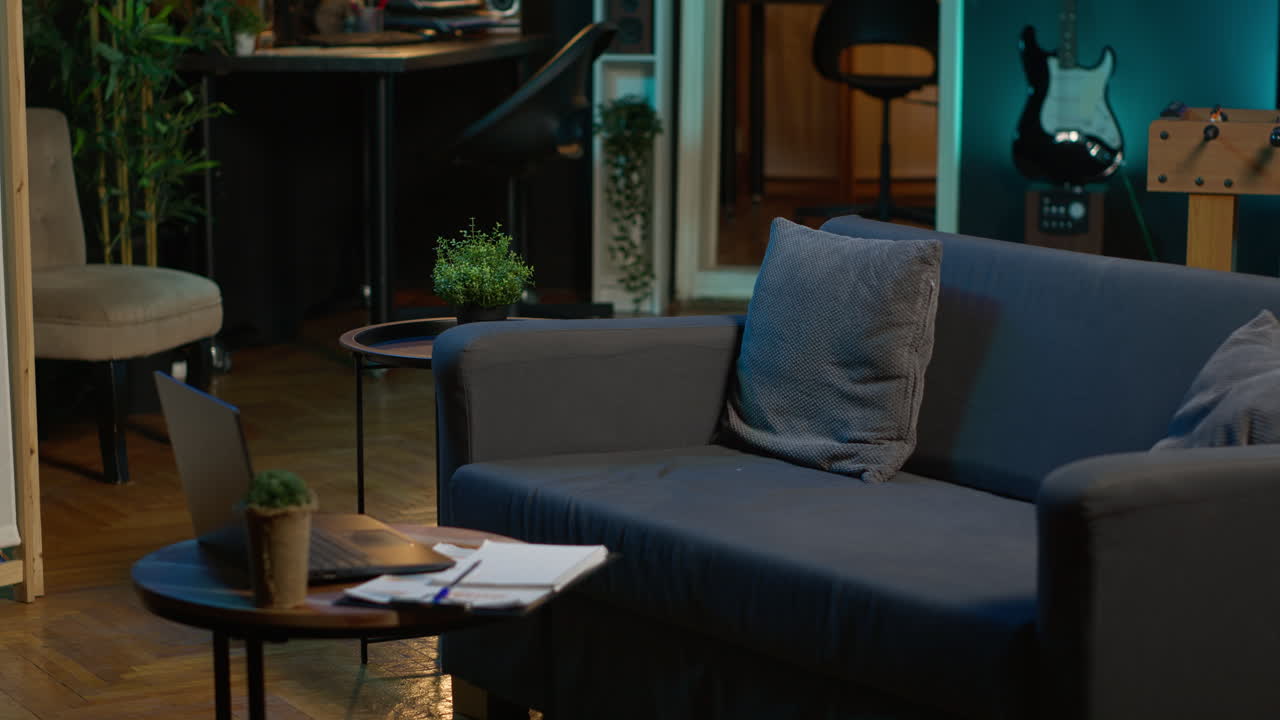 Cozy apartment with modern decor and trendy electronics creating a relaxation space, stylish minimalist studio loft with a smart tv and a coffee table. Comfortable home with indoor plants.