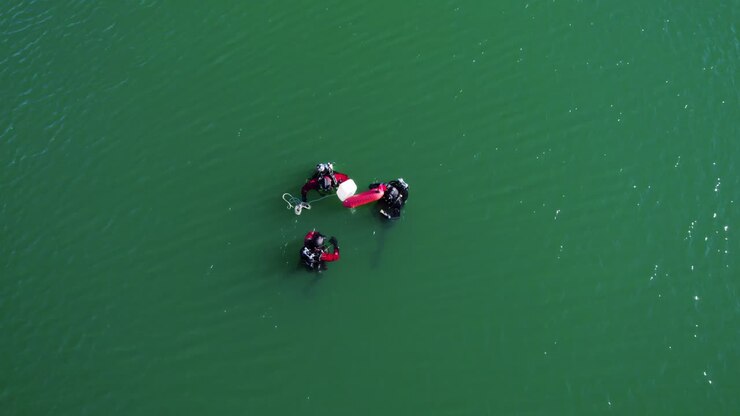 Three divers searching for an object in a lake in the south of France