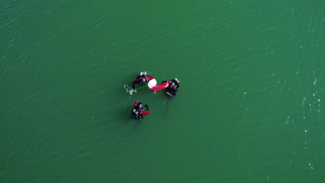 three divers searching for an object in a lake in the south of france