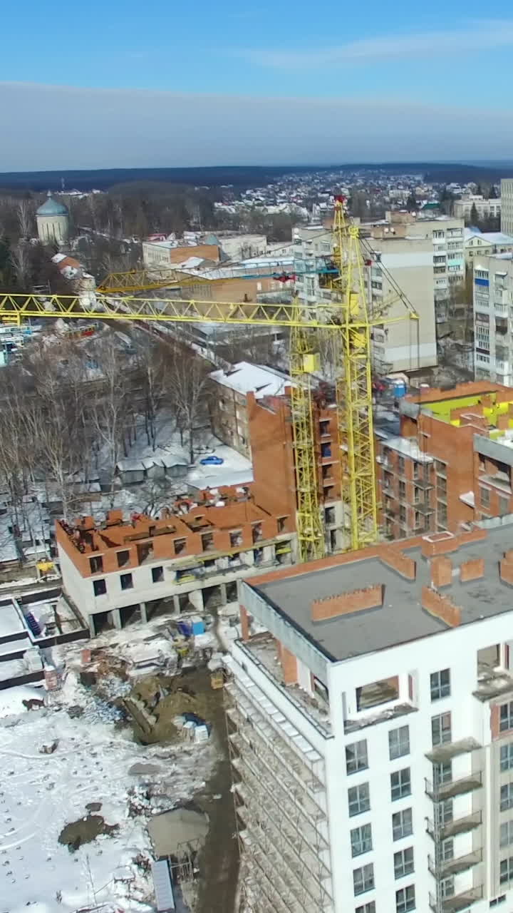 New house construction. Large apartment buildings construction in new district among houses