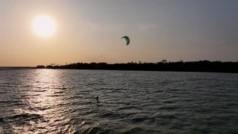 lone kitesurfer at violet andrews park area in portland, texas at sunset