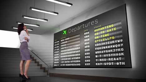 businesswoman looking at departures board