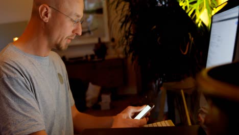 man using mobile phone and desktop computer 4k