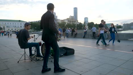 street musicians performing on a city bridge