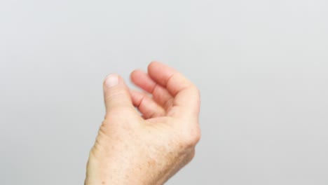 a senior female's hand snapping while isolated on a white background