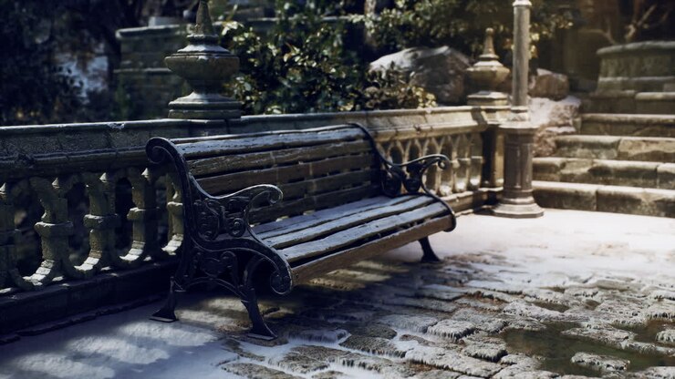 Snow covered bench beside stone railing in a tranquil winter garden setting