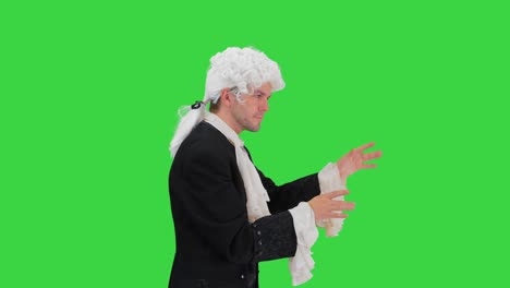 man dressed like mozart conducting while walking on a green screen, chroma key