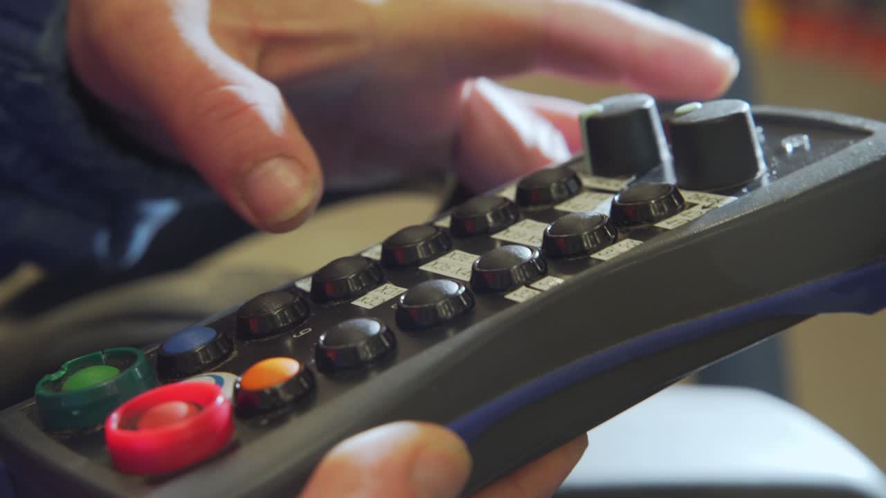 Operator using a machine control panel