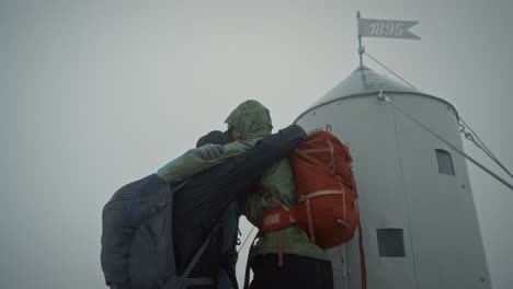 hikers hugging them and congratulating for the successfull climb on mountain triglav