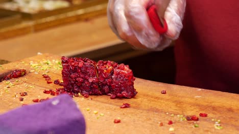 close up of a person cutting turkish delight