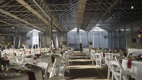 empty wedding venue in a warehouse, white dining table arrangement with flowers