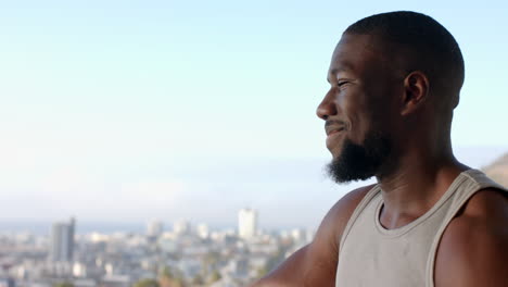 relaxing at home, african american man enjoying peaceful moment with city view