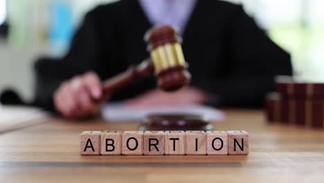judge and 'abortion' blocks representing legal issues