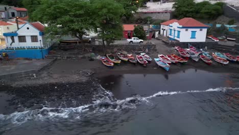 Fishermen-On-A-Wooden-Boat-With-Settlements-In-Cidade-Velha,-Santiago-Island,-Africa