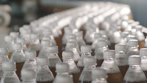 conveyor belt with bottles for juice or water at a modern beverage plant. modern production of sweet soda water