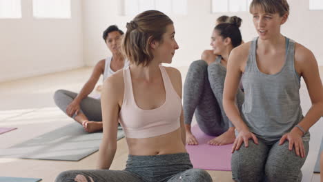 happy yoga women friends chatting enjoying socializing having conversation in fitness studio ready for training practice