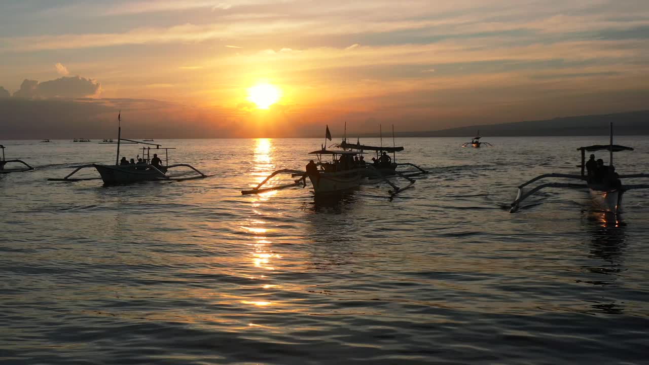 antena de hermosa silueta de botes jukung indonesios en tour de delfines con turistas al amanecer en lovina bali indonesia