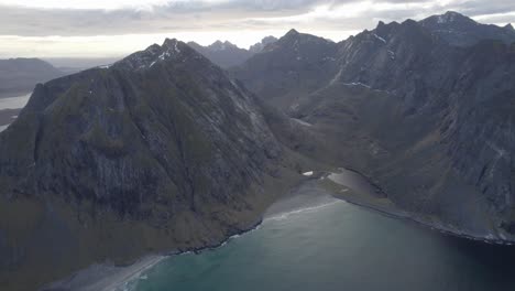 aerial view overlooking the vestervika beach, cloudy autumn day in lofoten, norway - tracking, drone shot