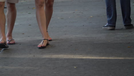 two people wearing shorts and sandals walking together