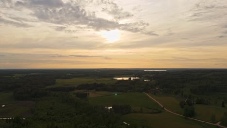 peaceful aerial shot of a vast latvian landscape with lakes and winding roads