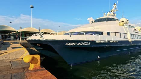 a boat approaches and docks at the harbour