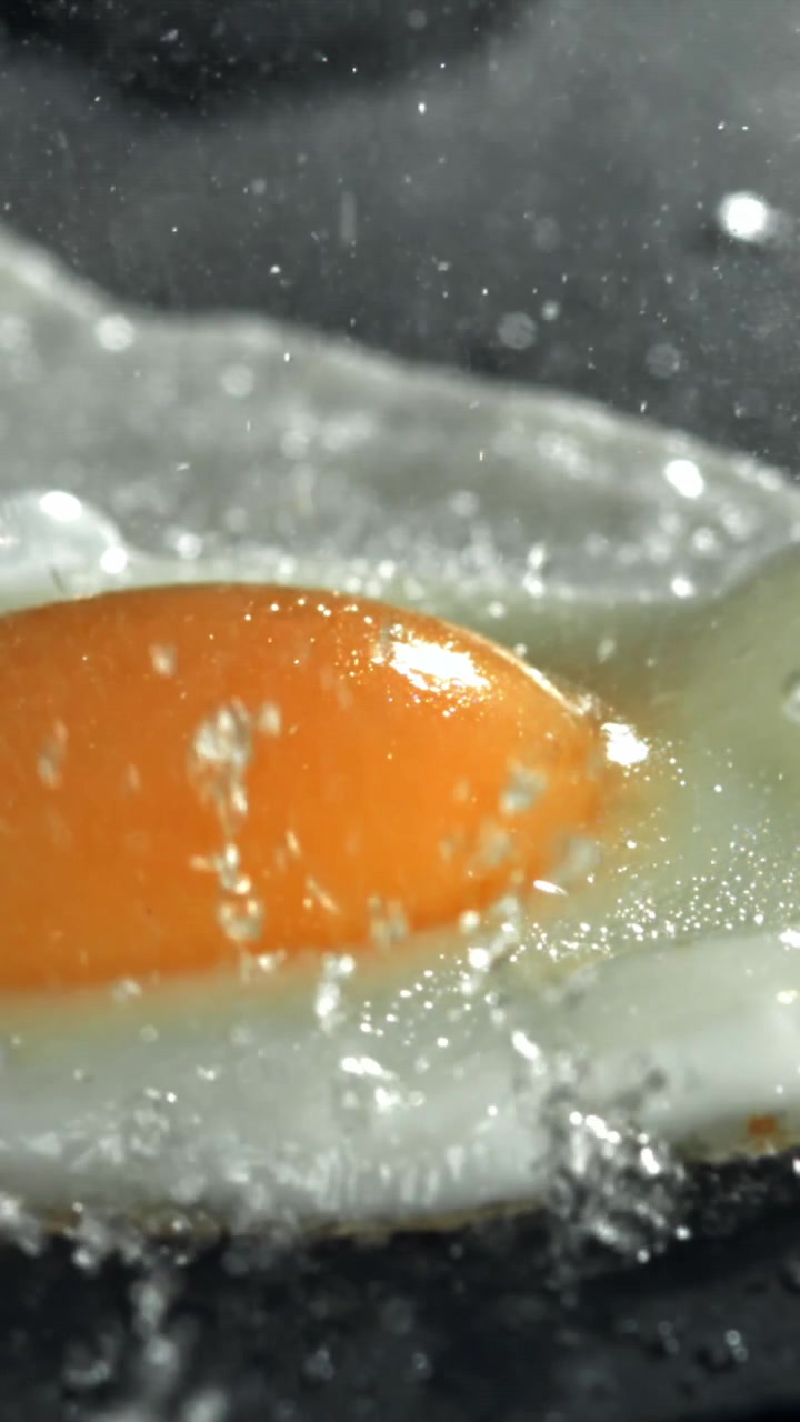Close-up of a Fried Egg Sizzling in a Hot Pan