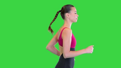 beautiful sporty girl running or jogging on a green screen, chroma key