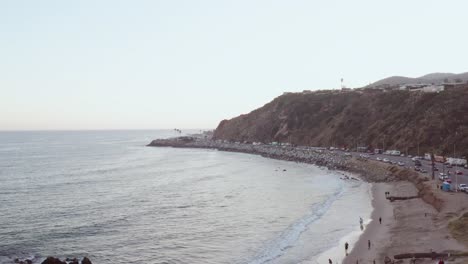 Aerial-drone-shot,-over-Malibu-beach-Pacific-Coast-Highway-with-traffic-of-cars