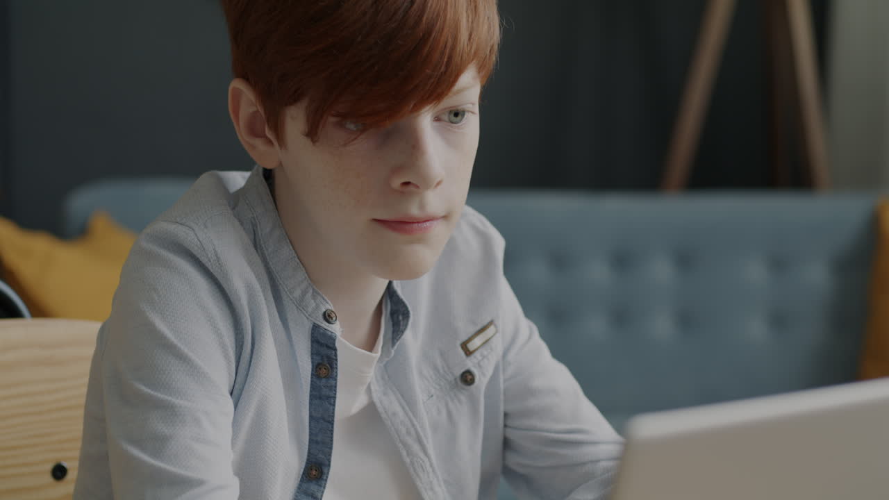 Teenage boy working on a laptop