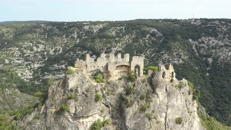 aerial shot flying over ruins castle of verdun or the giants in saint guilhem