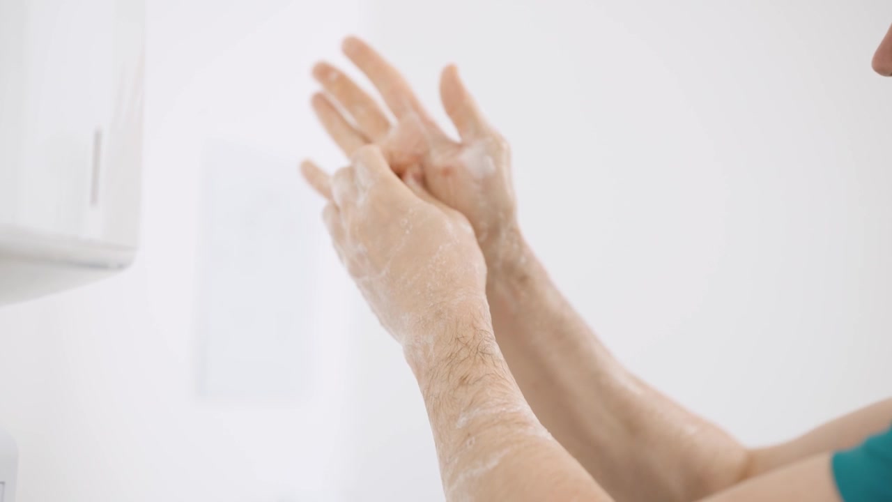 Medical Professional Washing Hands with Soap in Hospital