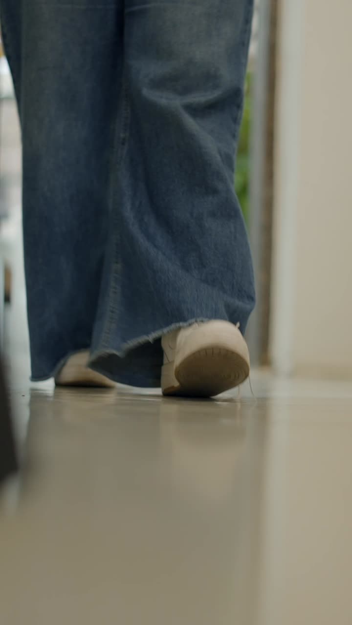 Person Walking in Jeans and Sneakers