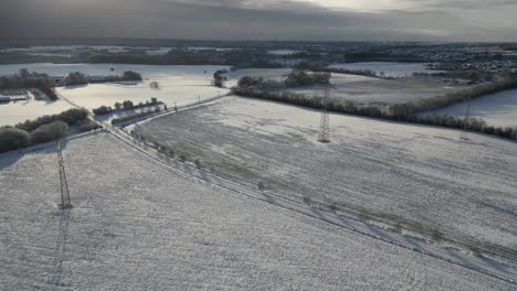 Drone-footage-of-snowy-fields-on-a-beautiful-winter-day