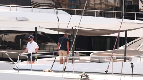 two men working on a yacht