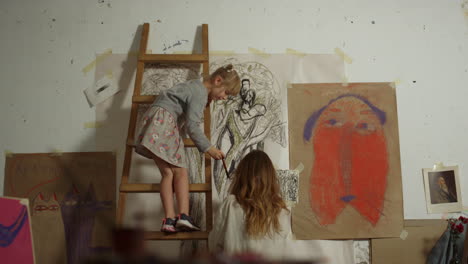 girl and art teacher painting in art school