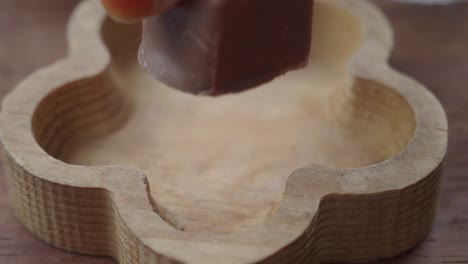 close-up of a piece of chocolate on a wooden dish