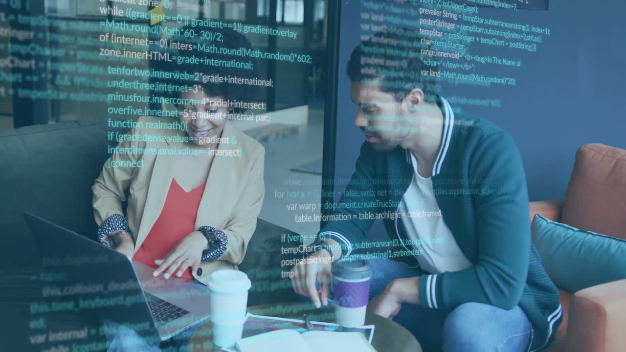 Upon placing laptop on couch woman and man reviewing code with floating lines showing tech focus