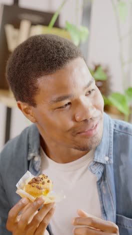 young man enjoying a sweet muffin