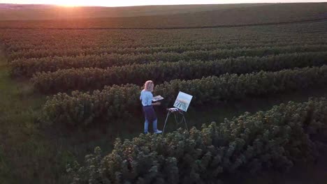 girl artist paints a picture with oil paints
