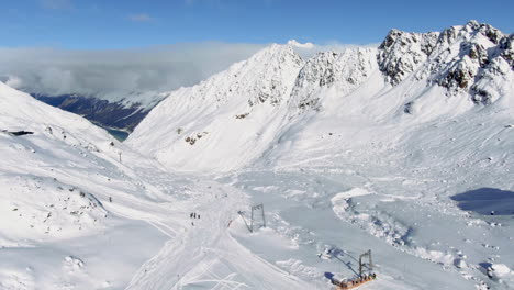 aerial birds eye shot over ski region with many skier skiing downhill snowy slope in winter season kauntertal, austria