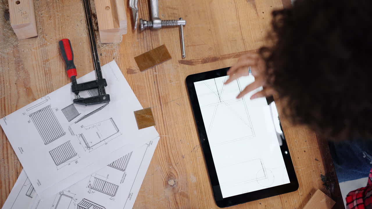 Woodworker Designing Furniture on a Tablet