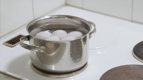 multiple eggs getting boiled in a saucepan. time-lapse