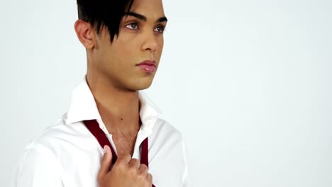 androgynous man posing against blue background