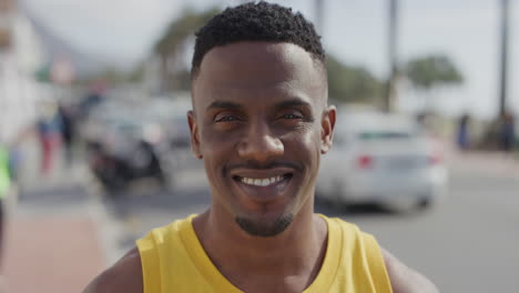 portrait of attractive african american man smiling cheerful looking at camera enjoying summer vacation in urban city waterfront handsome black male happy satisfaction