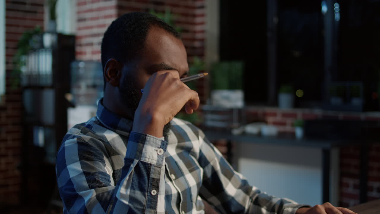 Pensive trader thinking about forex sales solution on laptop