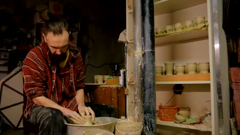 professional male potter working in workshop